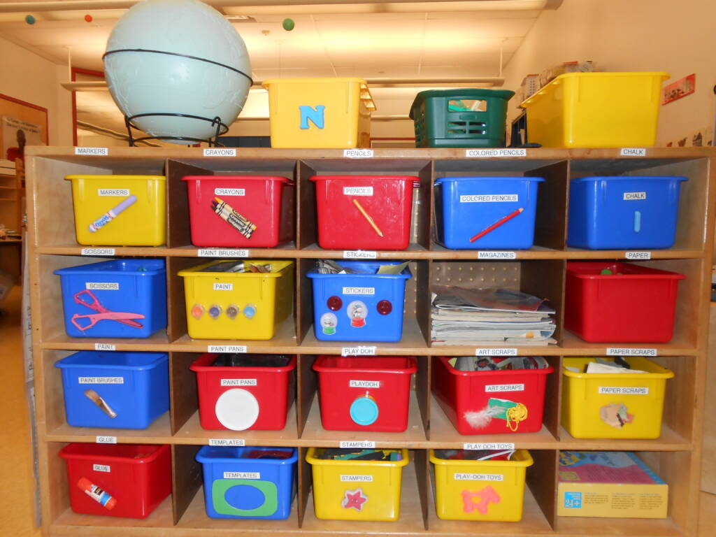 Bins with objects affixed to the outside