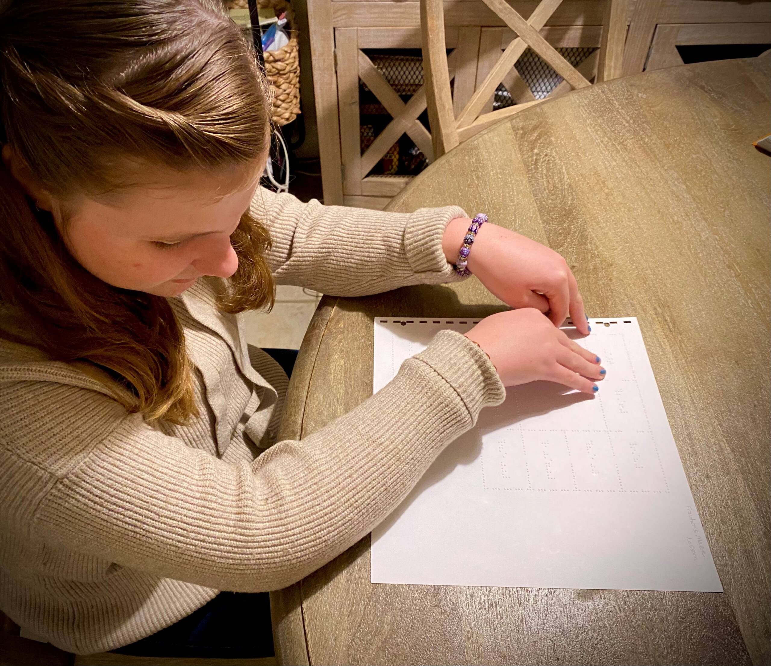 Girl reading braille