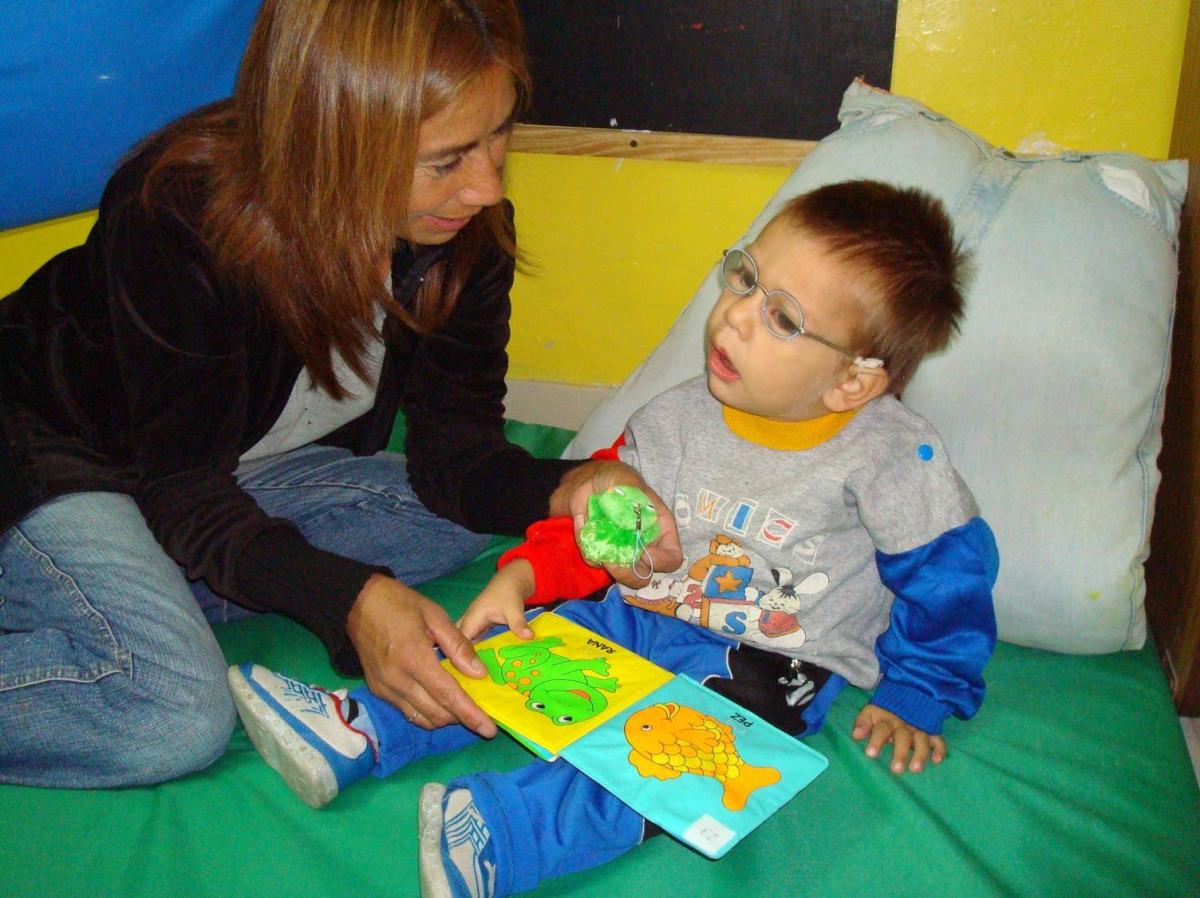 Mother exploring a book with her infant child