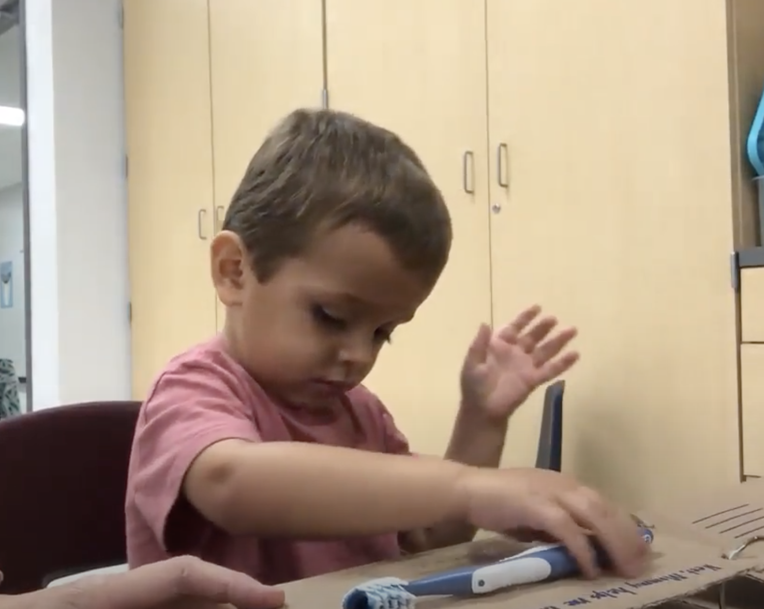 Young child exploring a toothbrush