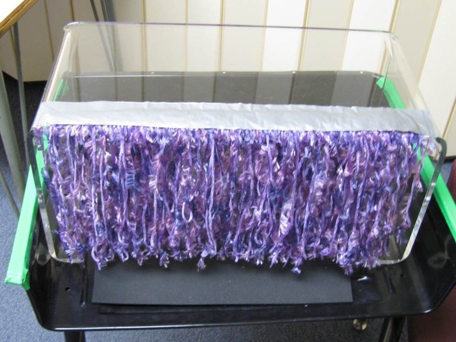a reading box is decorated with a purple cloth