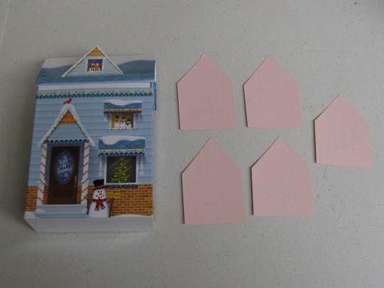 a cardboard house with note cards for each family member