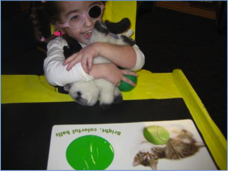 child hugging stuffed cat