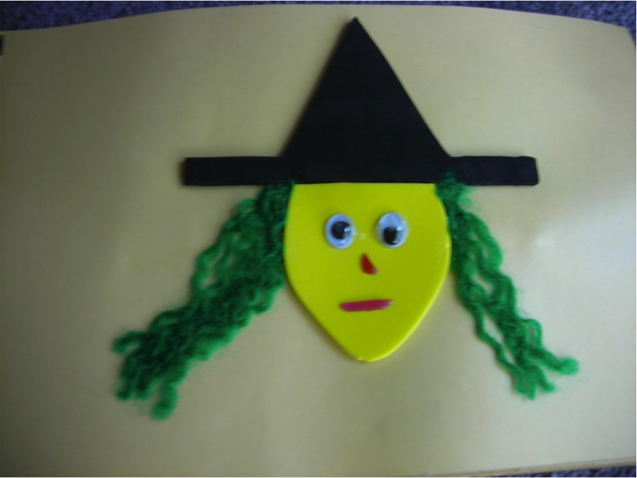 a picture of a witch with a black hat and green hair