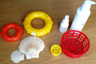 small and large objects around the house, shells, spray bottle, basket, toy rings