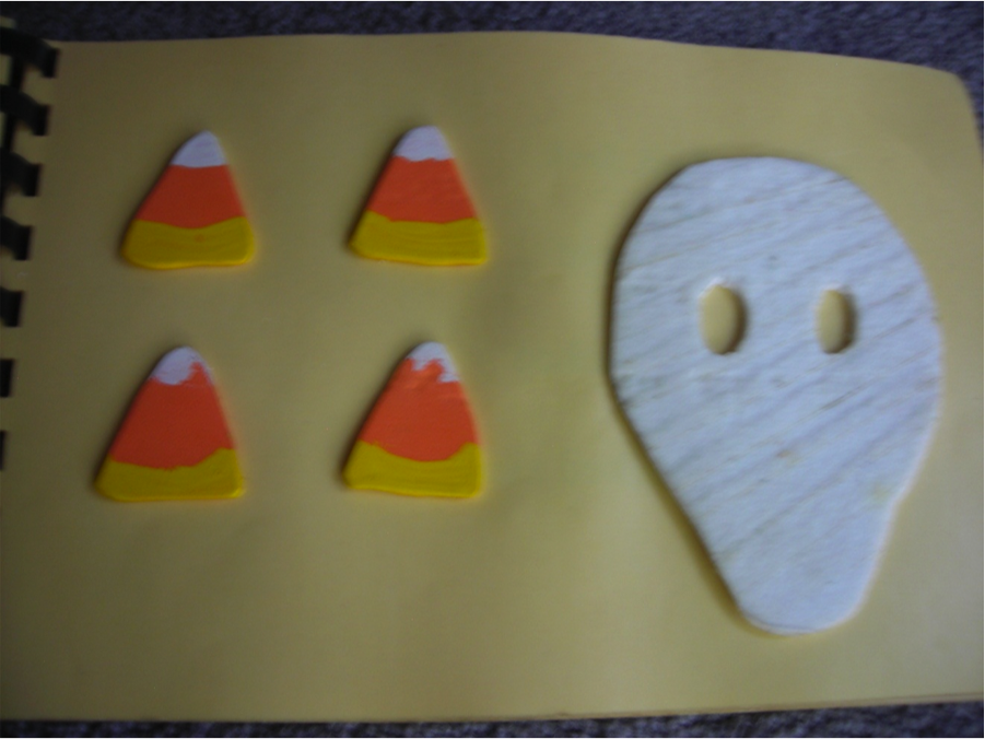 mummy with four pieces of candy corn