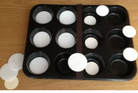 muffin tins filled with bottle lids