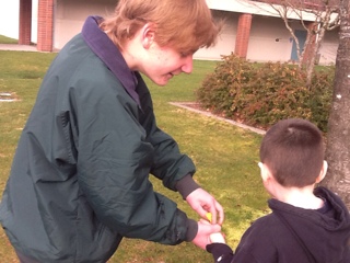 two students holding water balloon