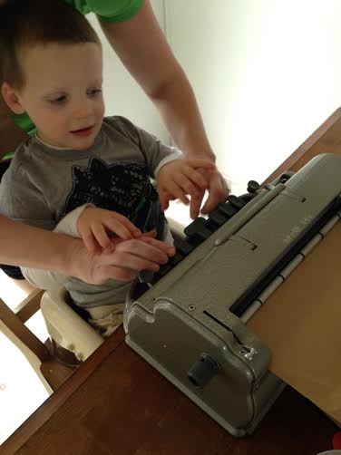child using braille writer
