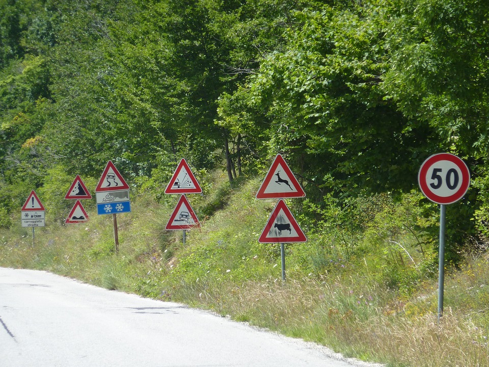 many different signs next to a road