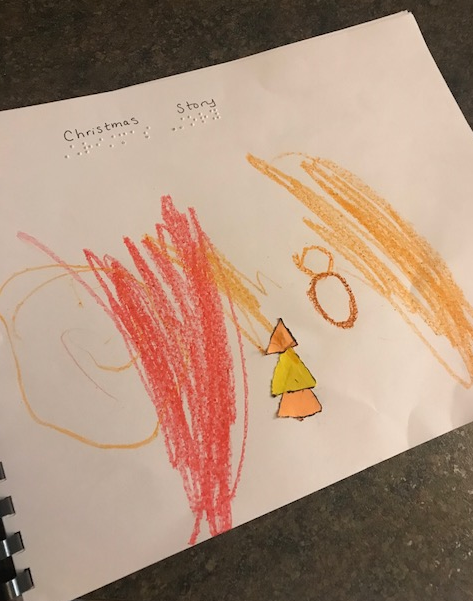 Click to enlarge the book cover that Liam illustrated. cover of Christmas Story with crayon pictures and shapes made with the black board