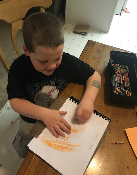 Click to enlarge the picture of Liam illustrating the story. Liam illustrating a page of the story