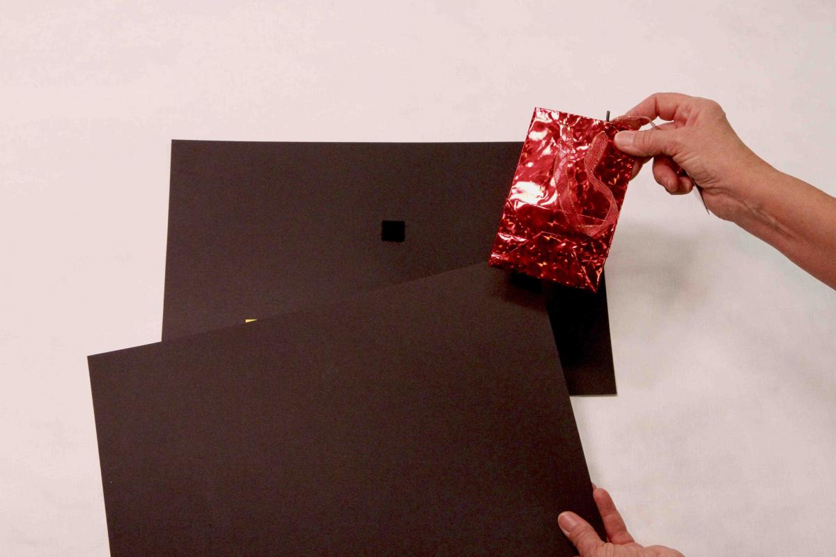 Red mylar gift bag with black background and Velcro square