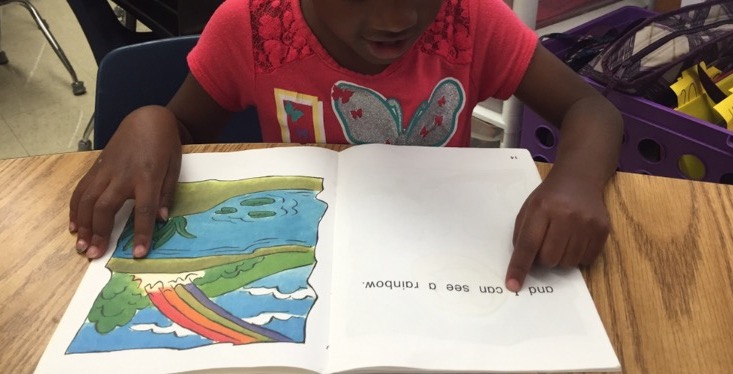 Girl reading large print