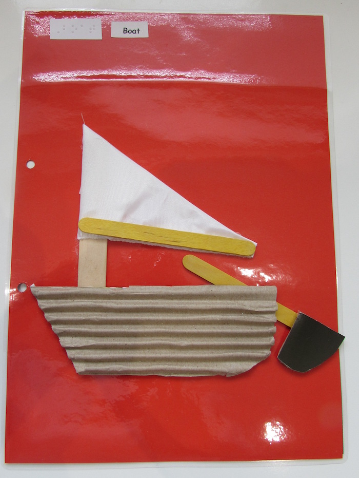 tactile boat on red paper