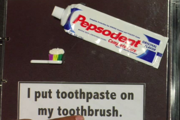 putting toothpaste on toothbrush