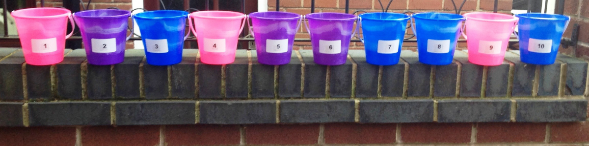10 buckets sitting on a wall