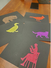 Colored silhouettes of animals on black pages Colored silhouettes of animals on black pages
