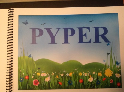 the name Pyper in the sky above a field with flowers and butterflies