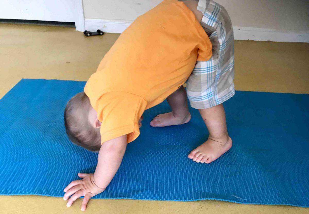 Child doing Downward Dog pose