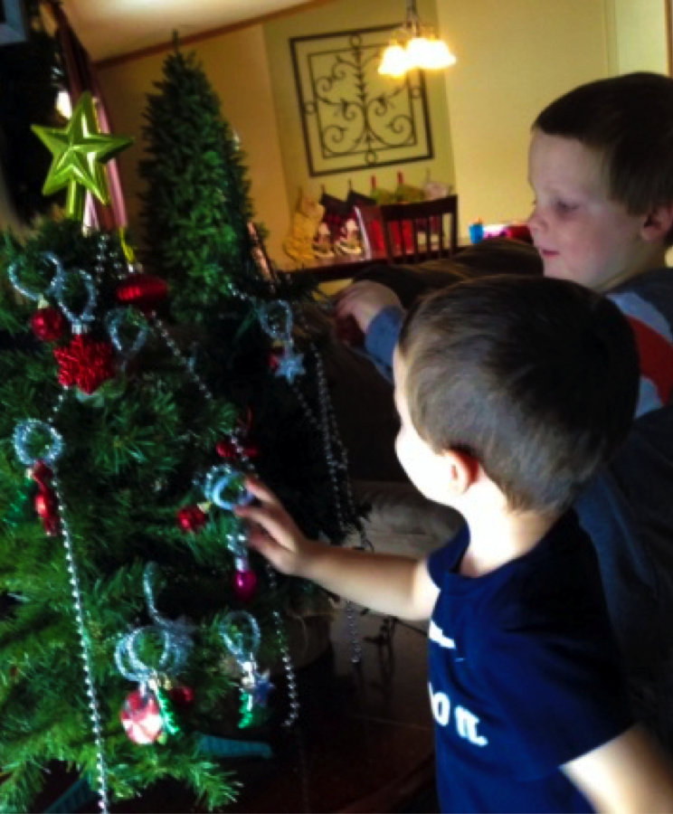 liam and friend hanging ornaments on tree
