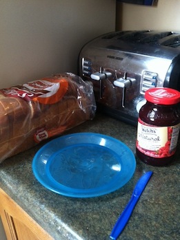 A toaster with a jar of jelly