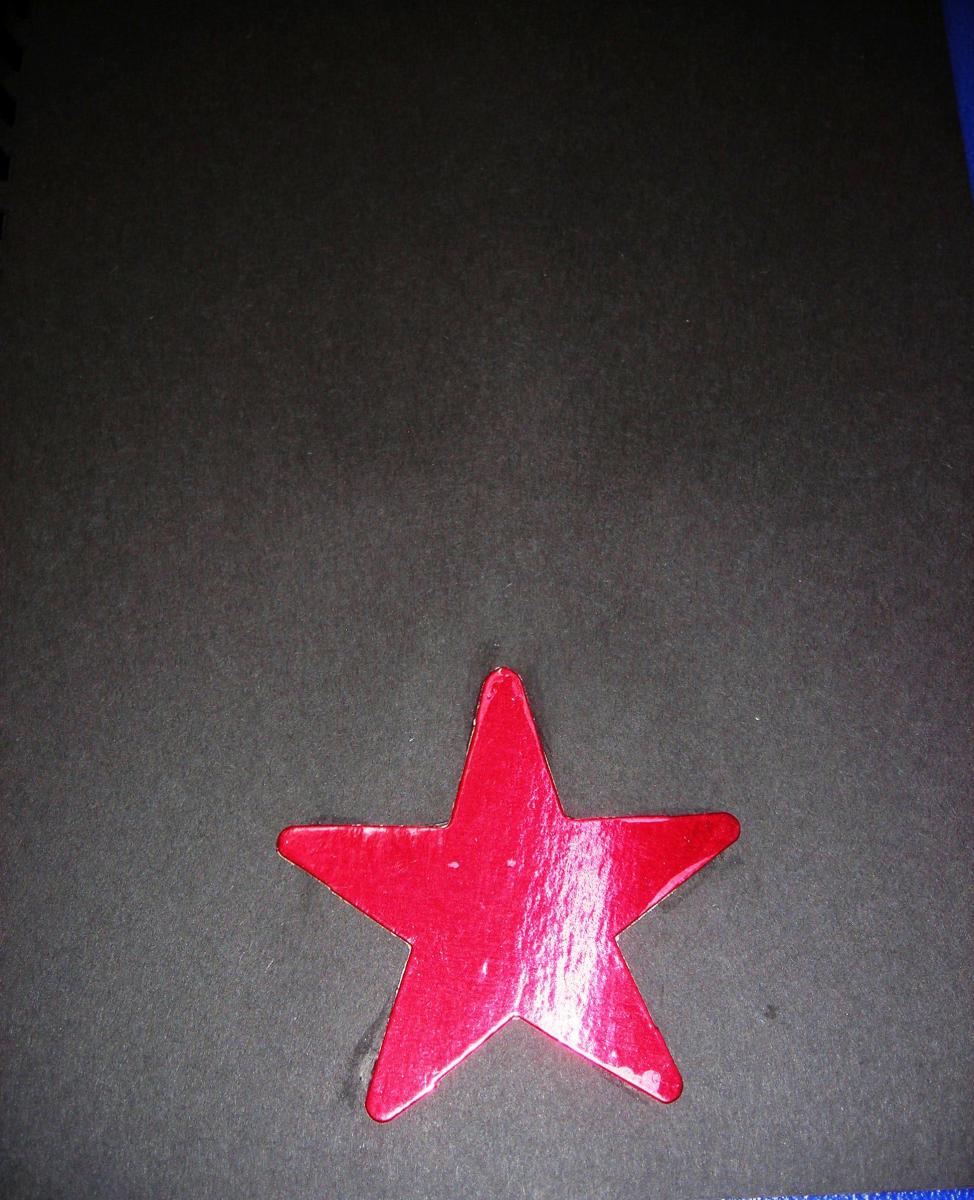 Red star on black paper