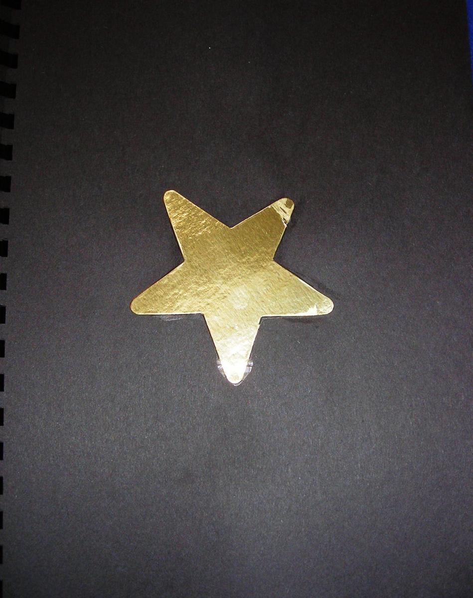 Gold star on black paper