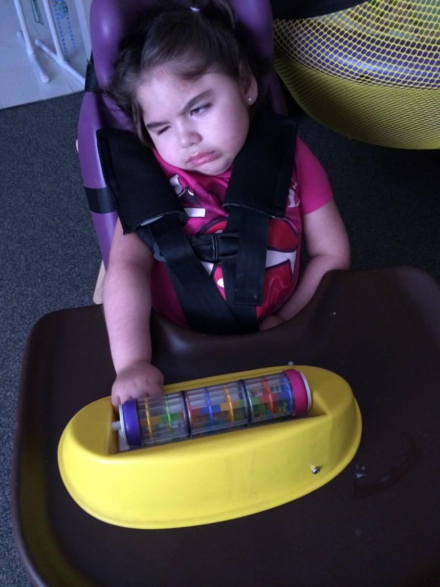 Student in chair with sensory toy