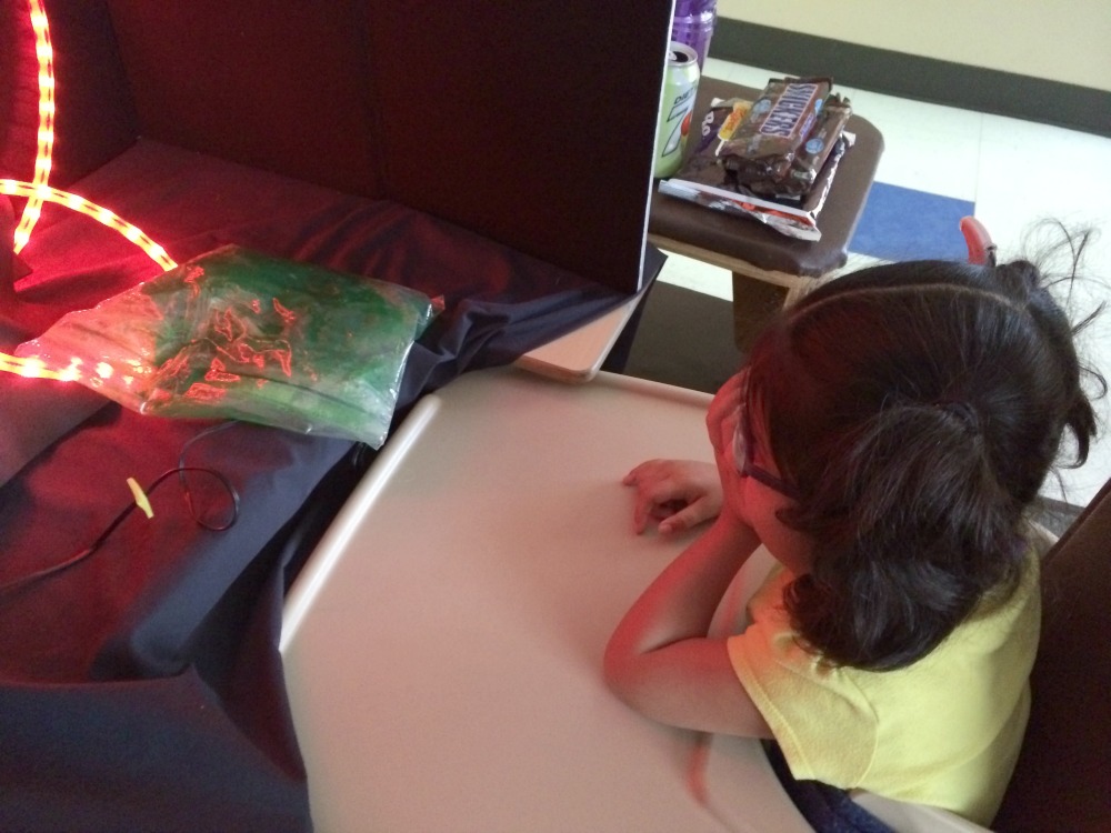 Student looking at red string light