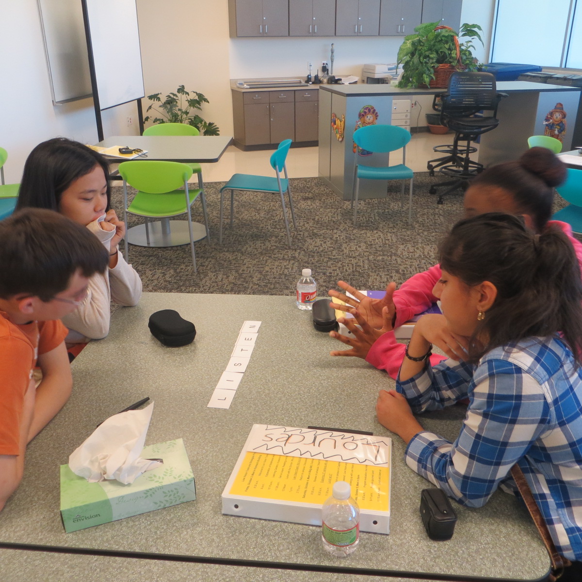 students having a discussion around the table