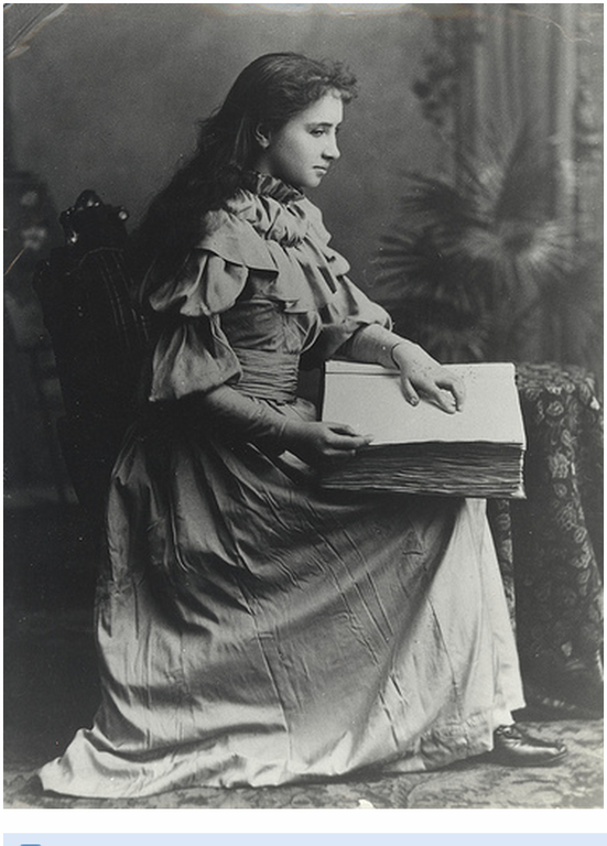 Helen Keller reading an embossed book