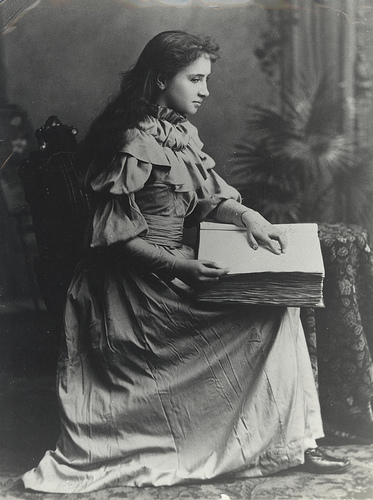 Helen Keller reading a braille book