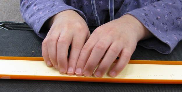 Strips can be made with lines of dots 2, 5 with: craft shapes, full cells, letters, words, names Girl reading braille strips