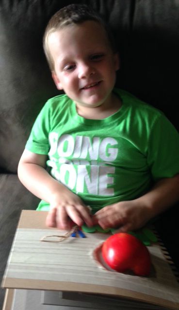 liam in green shirt with hungry caterpillar adapted book