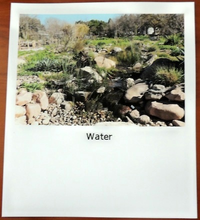 Index card with an image of a stream surrounded by grass and rocks