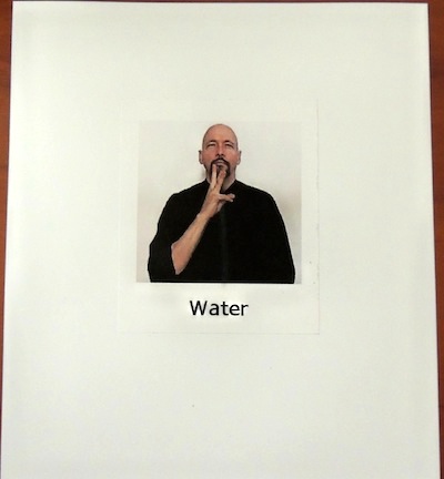 Index card with a picture of a man signing