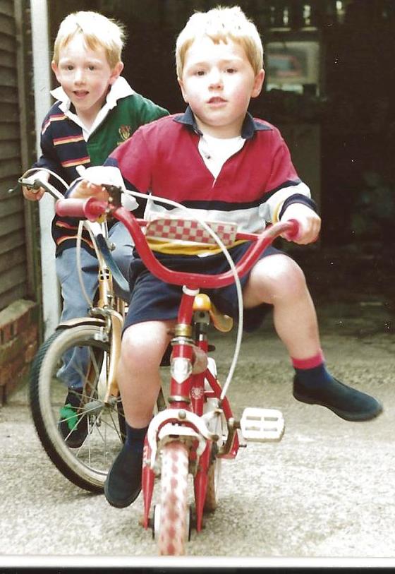 two boys riding bikes
