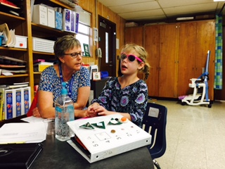 A girl working individually with her teacher