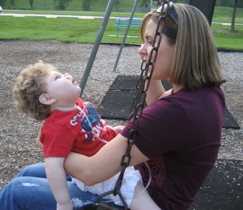  woman is swinging with a child in her lap