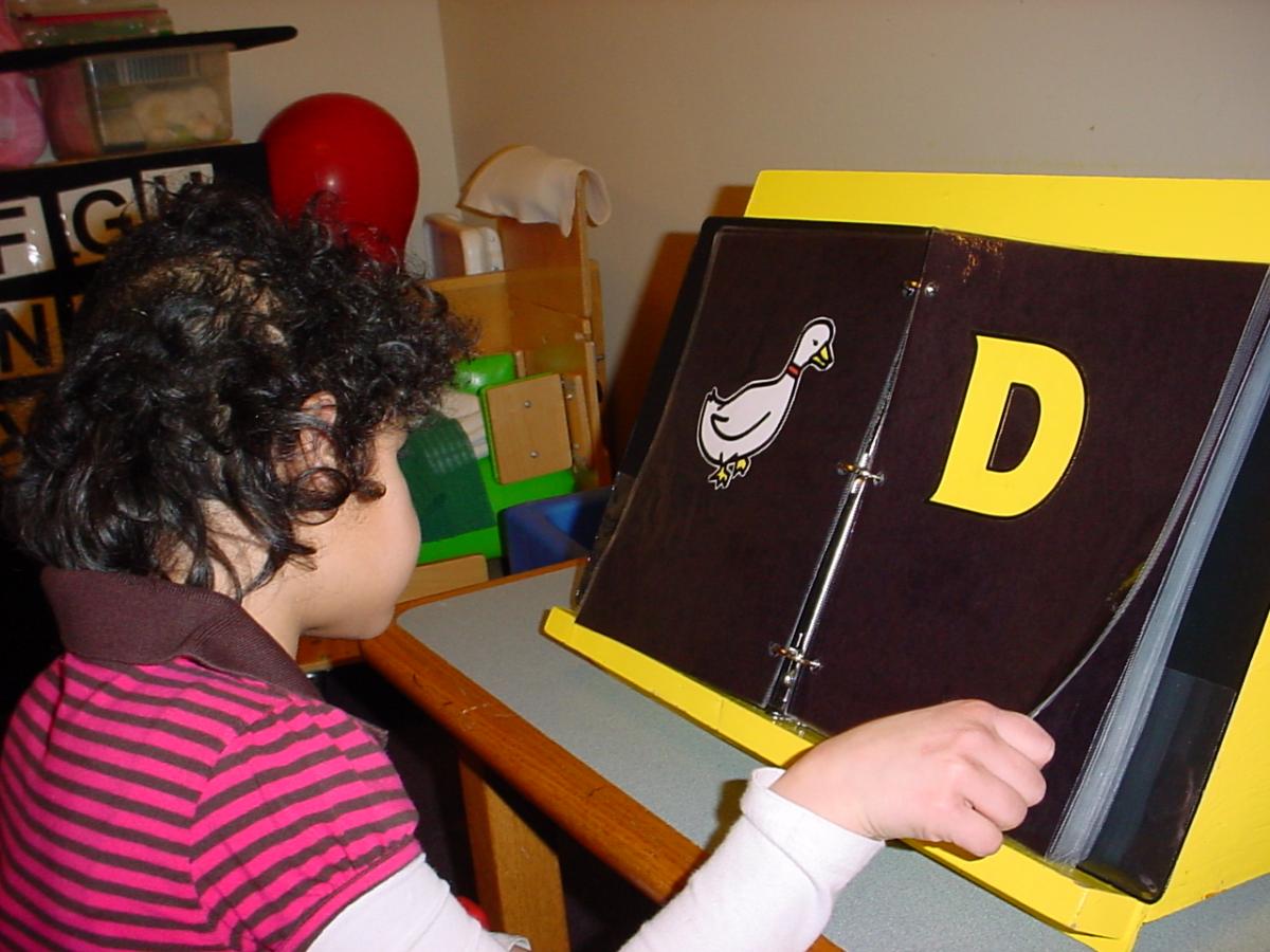 Child uses a slant board