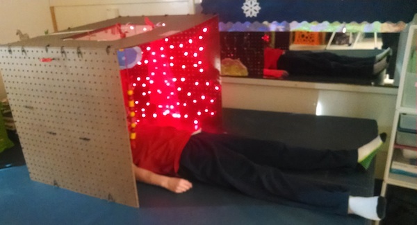 student laying inside little room