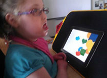 A girl sits in front of a lightbox