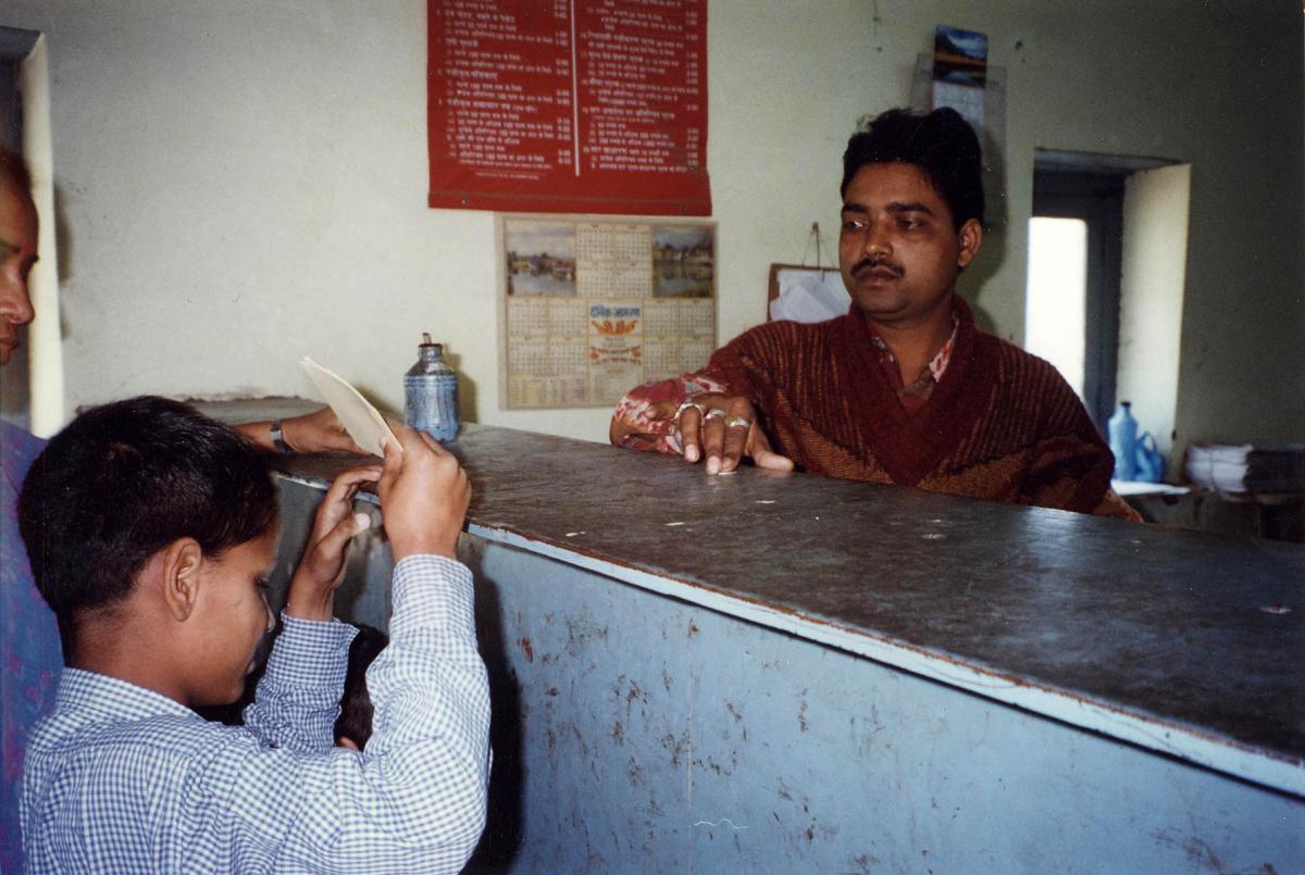 Purchasing postcards at the post office