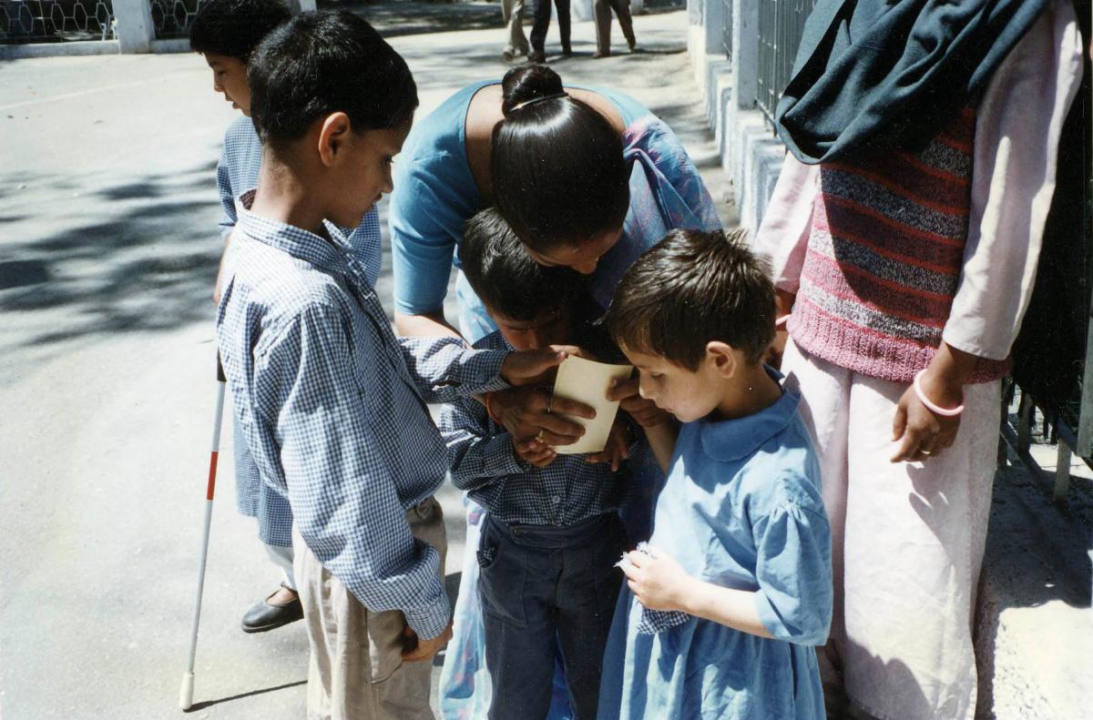 Younger children count the postcards with their teacher.