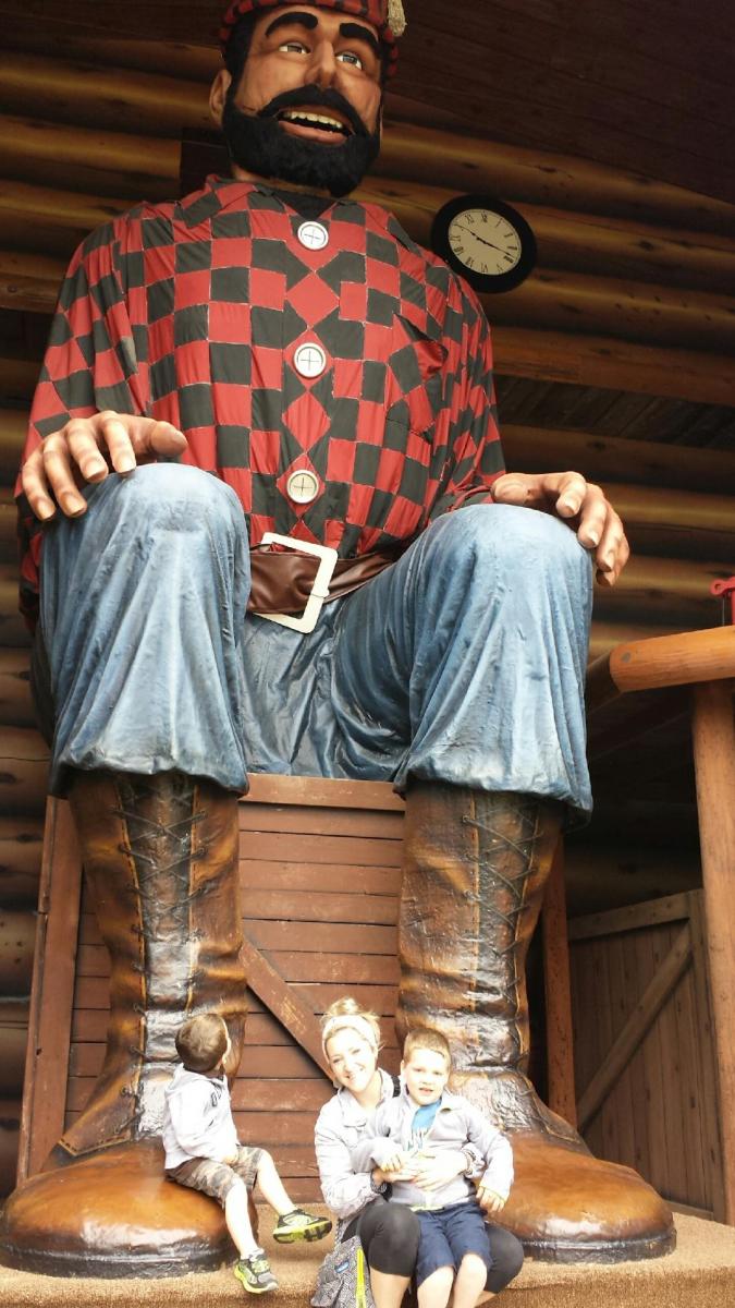 Sitting at feet of Paul Bunyan statue