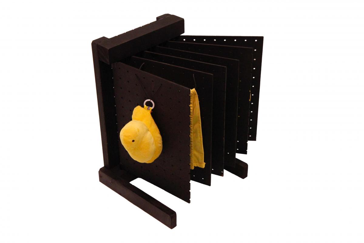 Pegboard book with yellow objects attached