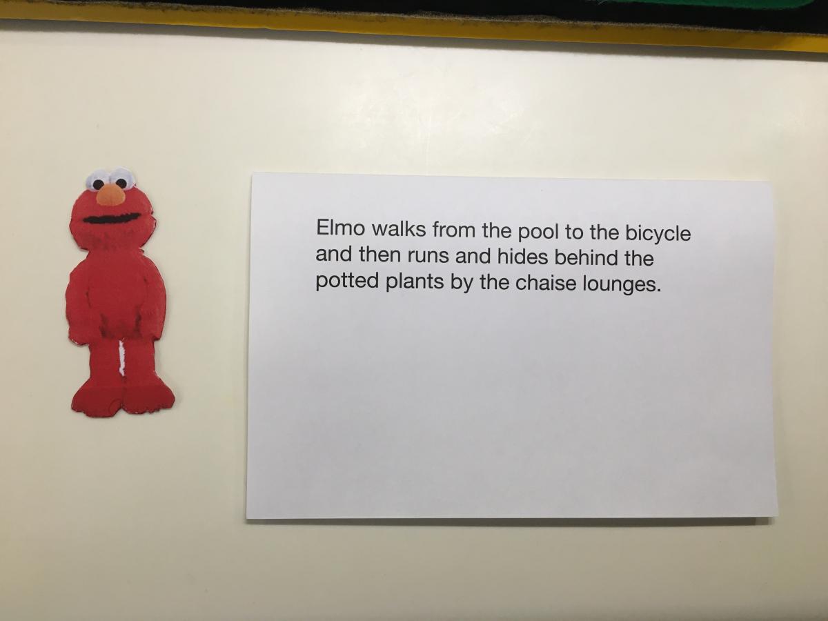 Elmo with card describing where he will walk.