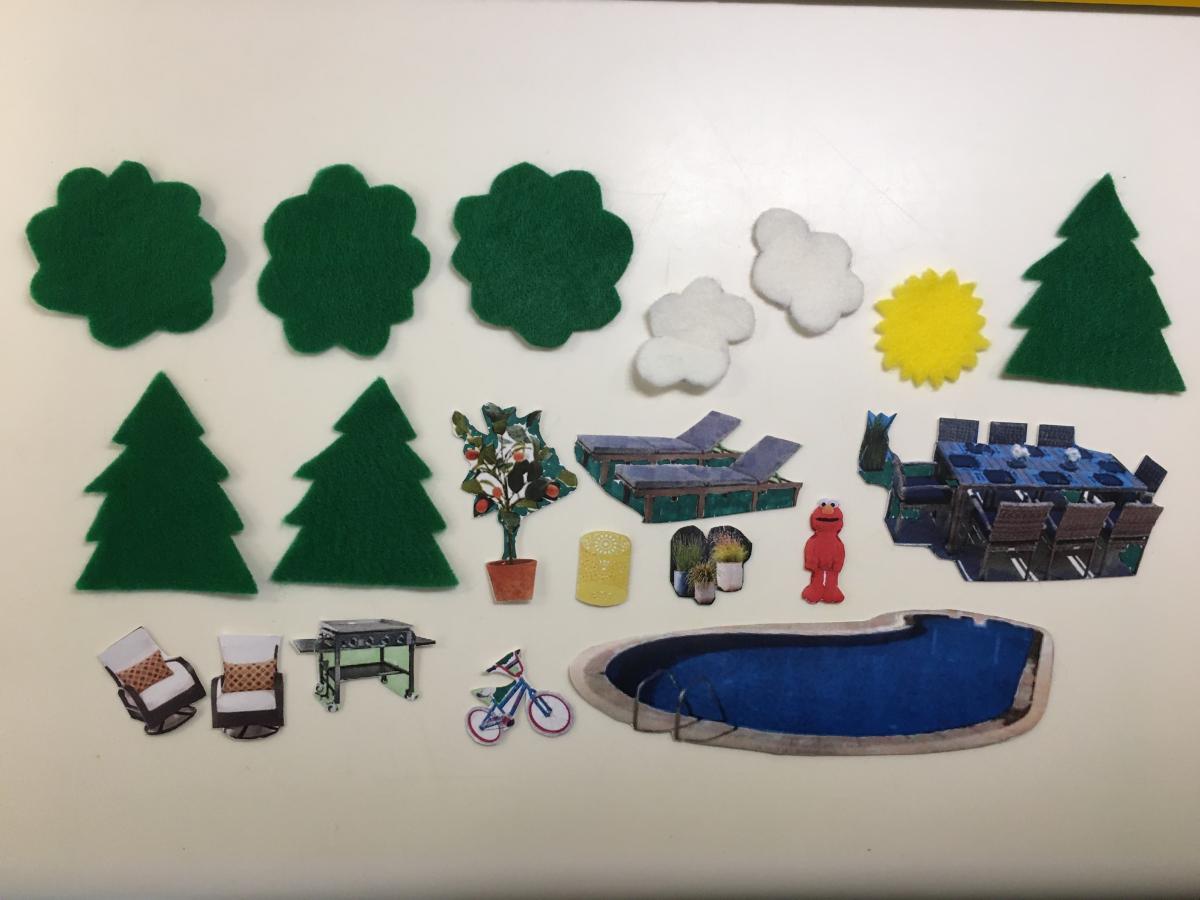 Trees, clouds, pool, lounge chairs, and Elmo cut outs