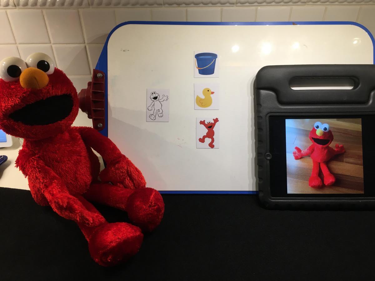 Elmo with photo of Elmo on iPad and black & white Elmo drawing